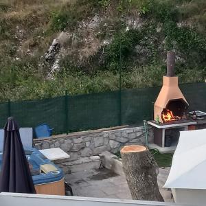 a fire pit with a stove in a backyard at Kuća Melita -jacuzzi in Kastav
