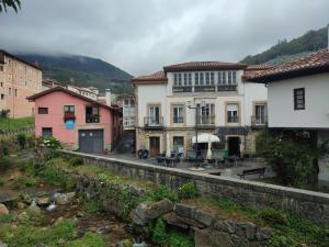 a group of buildings in a town next to a river at BlueMedina Superior Salas in Salas