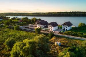 an aerial view of houses on the shore of a lake at Amore Resort in Băltenii de Sus