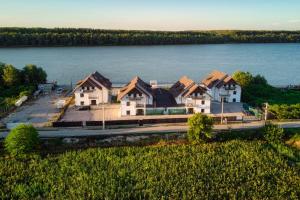 an aerial view of a house by the water at Amore Resort in Băltenii de Sus