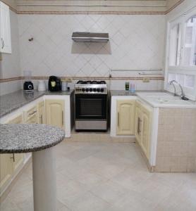 a kitchen with a stove and a sink at JasminVilla in Sousse