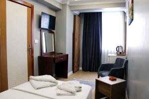a hotel room with a bed and a chair and a mirror at biglife hotel in Istanbul