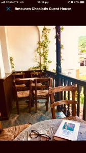 a room with chairs and a table with a book at 9mouses Chasiotis Guest House in Ampelakia