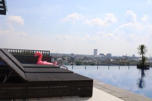 a pink duck sitting on a bench next to a body of water at ibis Palembang Sanggar in Palembang