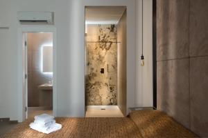 a bathroom with a shower with a towel on the floor at Hotel Diamond in Naples