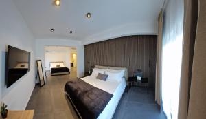 a hotel room with a large bed and a bedroom at Sicily Milazzo SeaFront Rooms in Milazzo