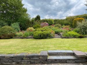 a garden with a bunch of bushes and flowers at The Bungalow By Birch Stays in Pentraeth