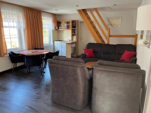 a living room with a couch and a table at Altstadtapartments in Wernigerode