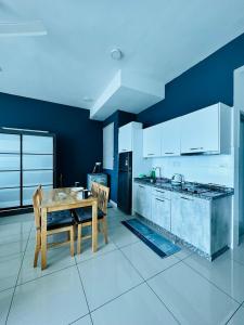 a kitchen with a wooden table and a dining room at Lavender by AK Group in Cyberjaya