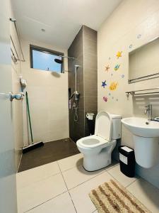 a bathroom with a toilet and a sink at Lavender by AK Group in Cyberjaya
