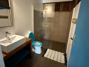 a bathroom with a sink and a toilet and a shower at Moorea Pool & Lagoon House in Moorea +14 photos