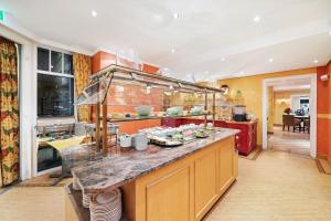 a kitchen with a counter with food on it at Strandhotel Sylt Westerland in Westerland
