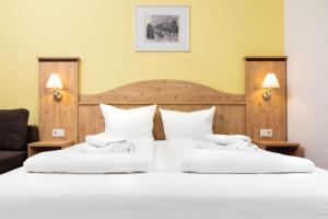 2 Betten in einem Hotelzimmer mit weißen Kissen in der Unterkunft Gaststätte & Pension Waldschlösschen in Oberhof