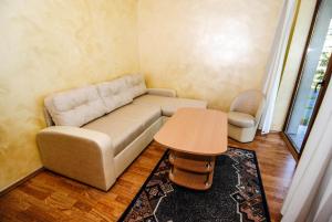 a living room with a couch and a table at Guest house Ieva in Šventoji