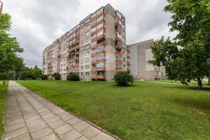 an apartment building with a green lawn in front of it at A.P. Apartment in Šiauliai