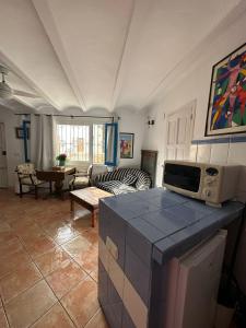 a living room with a microwave on top of a counter at Loft en Mojácar in Mojácar +10 photos