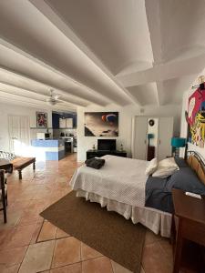 a bedroom with a large bed and a living room at Loft en Mojácar in Mojácar