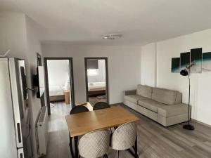 a living room with a table and a couch at Serenity Haven Retreat in Floreşti