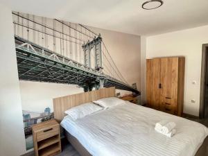 a bedroom with a bed with a bridge on the wall at Serenity Haven Retreat in Floreşti