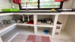 a kitchen with a sink and a counter top at Cocotier du Rocher in La Digue