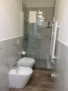 a bathroom with a toilet and a sink and a shower at Chagall Charme in Asti +2 photos
