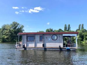 a house boat on the water on a river at Hausboot NautikHus auf der Havel in Kolonie Zern