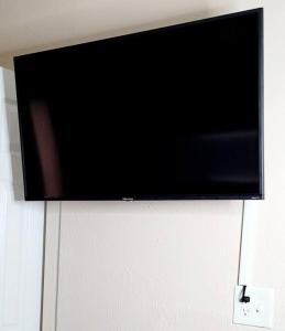 a flat screen tv hanging on a wall at Cozy By The Sea - Hutchinson Island - A in Fort Pierce