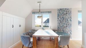 a dining room with a table and chairs at Beachhouse Beachhouse 5 in Hörnum +6 photos