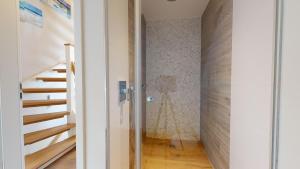 a hallway with a staircase and a door to a room at Beachhouse Beachhouse 5 in Hörnum