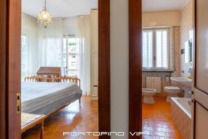 a bedroom with a bed and a bathroom with a sink at Appartamento Via Madonnetta by PortofinoVip in Santa Margherita Ligure