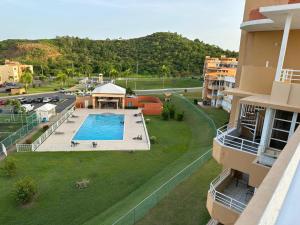 an aerial view of an apartment complex with a swimming pool at Pearl of the East in Ceiba an entire Penthouse with Ocean View in Santa Maria