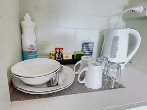 a kitchen counter with a mixer and a bowl and cups at Gloucester Motel Pemberton Manjimup in Pemberton