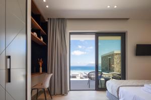a bedroom with a view of the ocean at Magical new luxury villa Camellia! in Kissamos +54 photos