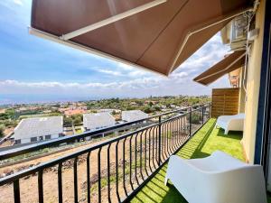 een balkon met uitzicht op de stad bij Carrubba's luxury home in San Giovanni la Punta