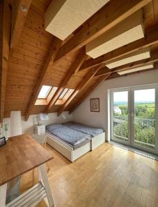 a bedroom with a bed and a large window at Panorama-Suite Birkenbeul in Birkenbeul