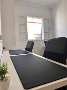 a meeting room with a table and two chairs at WELKAM Home & Coworking in Essaouira