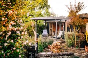 a house with a porch with a bunch of fire wood at Starry Nights cabin fever in Waikino