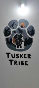 a tusker tribe logo on a wall at Tusker Tribe in Mysore