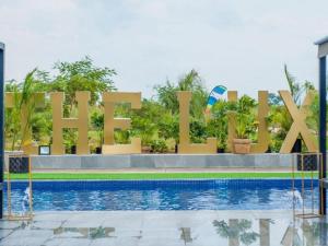 a sign for a hotel with a swimming pool at The Lux Hotel and Resorts in Louis Trichardt