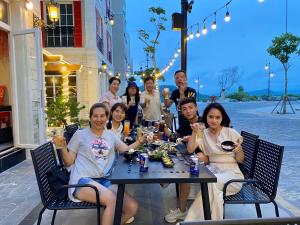 a group of people sitting at a table at Labe Hotel Phú Quốc - Sunset Town - Địa Trung Hải in Phú Quốc