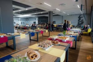 a room filled with tables with food on them at Hotel Sportowy in Ostrzeszów