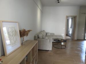 a living room with a couch and a table at DION APARTMENTS in Paleros