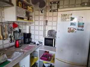 a kitchen with a white refrigerator and a microwave at Fuengirola Rooms Boliches Beach in Fuengirola