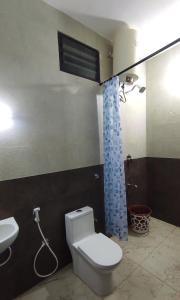 a bathroom with a toilet and a sink at Individual Villa Stay in Yelagiri +29 photos