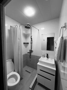 a white bathroom with a toilet and a sink at Al Bukhari Boutique Hotel in Bukhara