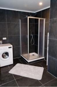 a bathroom with a shower and a washing machine at Wohnung Bruchsal in Bruchsal