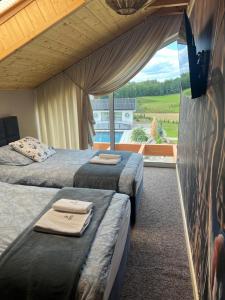 two beds in a room with a view of aestead at Czaple Resort in Stare Czaple