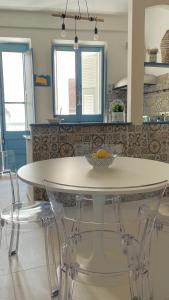 a kitchen with a white table and chairs at La residenza del sindaco in Carloforte