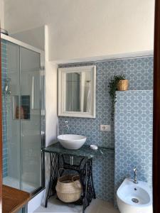 a bathroom with a sink and a shower and a toilet at La residenza del sindaco in Carloforte