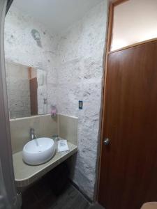 a bathroom with a sink and a mirror at Quinta Alpaca in Arequipa